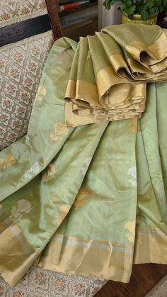 We are known for our genuine handloom weaves, specially our Chanderi collection.  It is a pure silk Eknaliya chanderi with a gorgeous mettaic gold finish in sage green with gold and silver big butas. The saree drapes like a dream and can beat any Banarasi saree to it.  Blouse piece: yes Pico: done Material: pure silk Zari: Pure Handloom: yes