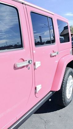 a pink jeep parked in a parking lot