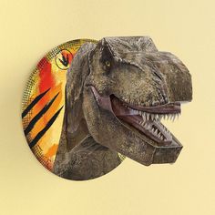 a dinosaur head mounted to the side of a wall with an orange and yellow background