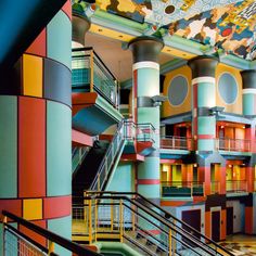 the interior of a multi - colored building with stairs