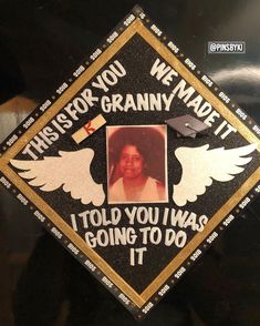 a graduation cap with an image of a woman's face and wings on it