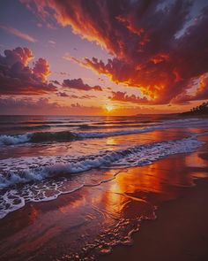 the sun is setting over the ocean with waves coming in to shore and clouds above