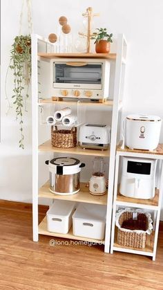 a kitchen shelf with pots and pans on top of it next to a microwave