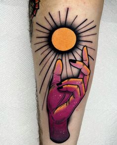 a person with a tattoo on their arm holding up a peace sign and the sun