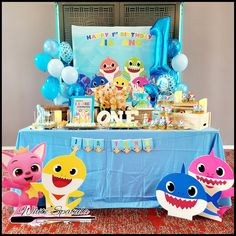 a baby shark themed birthday party with balloons and decorations