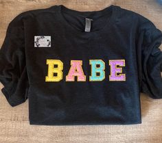 Babe Varsity Pastel Letter Tee/Long Sleeve Shirt & Crew Neck Sweatshirt Sweatshirts are a crewneck style WITHOUT A HOOD & WITHOUT A POCKET Additional t-shirt colors and writing color options available Crewneck Style, Flowy Tank Tops, Letter T, Baby Tshirts, Long Sleeve Shirt, Short Sleeve Shirt, Sweat Shirt, Sleeve Shirt, Colorful Shirts