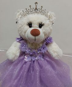 Quinceaner Teddy Bear with eyelashes  Embroidery of Mis 15 Años on the paw or without embroidery Lilac dress  20" height with the stand (cone) Crown and earrings (silver or gold) Dress is designed as shown in the images but can be made in different colors Lilac Color Dress, Embroidery Lilac, Quince Purple, Quinceanera Teddy Bear, Gold Quince Dress, Vestido Color Lila, Purple Quince, Quince Dress, 15th Birthday