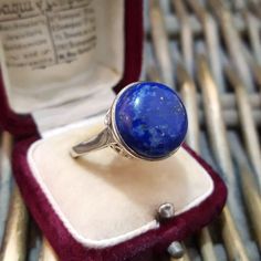 Impressive sterling silver ring Set at front with a natural blue lapis Lazuli Gemstone, 1.5cm in diameter Delicate pyrite matrix, lovely sparkle Retro scroll on the high setting Superb on Size N. 5 US 6.5 Marked 925 Tggc Very good condition Weight 6.1gr ALL GEMSTONES HAVE BEEN PROFESSIONALLY TESTED. JEWELLERY BOXES ARE FOR DISPLAY ONLY. Sterling Silver Rings Set, Lapis Lazuli Gemstone, Silver Ring Set, Blue Lapis, Jewellery Boxes, Rings Statement, 925 Sterling Silver Ring, Lapis Lazuli, Ring Set