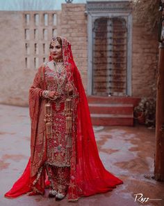 a woman in a red dress and veil