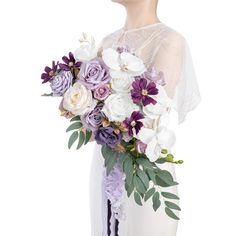 a woman holding a bouquet of purple and white flowers in her hands, wearing a bridal gown