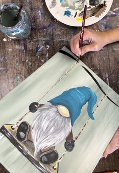 a person is painting on a piece of paper