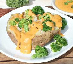 a white plate topped with potatoes covered in cheese and broccoli