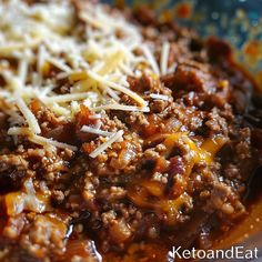 a bowl filled with chili and cheese on top of a table