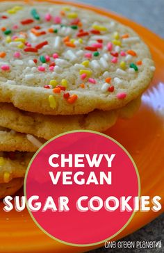 chewy vegan sugar cookies with sprinkles and candy on an orange plate