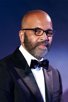 a bald man in a tuxedo and bow tie