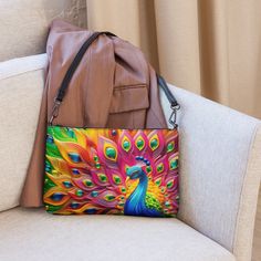 🦚Keep your style on point and your hands free with our Versatile Crossbody/Shoulder Bag Purse with a Unique & Colorful Peacock Design. It's made of premium faux leather and features dark gray hardware. Thanks to the zip-top closure and multiple inside pockets, you can keep your essentials secure and organized. Transform this crossbody bag with removable wrist and shoulder straps to style it for day-to-night looks. * Outer fabric: faux leather  * Lining: 100% polyester * 11″ × 8″ × 1.5″ (27.9 cm × 20.3 cm × 3.8 cm) * Dark gray hardware * Zip-top closure * Inside zip and slip pockets * Adjustable, removable wrist and shoulder straps * Strap drop length: 14″- 27″ Our Other Crossbody Bags: https://www.etsy.com/shop/ZazzFashion?section_id=45645921 Trendy Multicolor Clutch Bag, Trendy Multicolor Phone Bag For Daily Use, Trendy Multicolor Mobile Phone Bag, Multicolor Satchel Shoulder Bag With Mobile Phone Pocket, Multicolor Handheld Shoulder Bag, Trendy Multicolor Travel Clutch, Colorful Crossbody Travel Bag, Multicolor Large Capacity Crossbody Bag, Multicolor Large Capacity Pouch Shoulder Bag