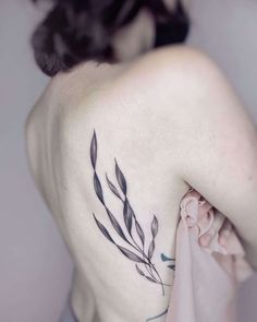 a woman with a tattoo on her back