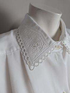 ⭐Description⭐ I'm all about classic blouses with fun details and this blouse definitely delivers.  Cute embroidery details on the collar. Pleated and the neckline with short sleeves ⭐Condition ⭐ Excellent condition. ⭐Measurements taken flat⭐ Pit to pit - 23" shoulder to shoulder - 19" length - 27" ⭐THANK YOU⭐ I am one woman on a mission to find beauty in discarded treasures and make sure they go to good homes where they will be used for years to come! ⭐NOTE⭐ Some of my pieces may show minor wear Fitted Embroidered Top With Collared Neckline, Fitted Floral Embroidery Top With Collared Neckline, White Blouse With Floral Embroidery And Peter Pan Collar, Classic Embroidered Collared Tops, Summer Tops With Floral Embroidery And Peter Pan Collar, Casual Embroidered Blouse With Peter Pan Collar, Spring Embroidered Blouse With Peter Pan Collar, Casual Blouse With Floral Embroidery And Peter Pan Collar, Spring Short Sleeve Blouse With Boho Collar