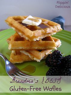 a green plate topped with waffles covered in syrup