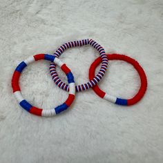 Handcrafted bracelets featuring vibrant red, white, and blue Heishi clay beads on a stretchy band. Size of bracelet in photo: 7 1/2 inches Cheap Red Heishi Beads Friendship Bracelets, Cheap Red Heishi Beads Bracelets, Bracelets Clay, Heishi Bead Bracelet, Bracelet Trio, Clay Bead Bracelets, Clay Bead Bracelet, Clay Bead, Handcrafted Bracelets