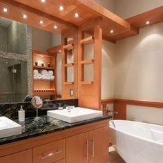 a large bathroom with two sinks and a bathtub in the middle of the room