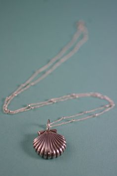 "This is a lovely fine silver scallop shell pendant and necklace. This item is new in my jewelry collection. The pendant was completely handmade by me. I'm so excited to share this new pendant and necklace. I created this pendant with metal clay. I created it from a mold. Each piece is carefully formed and filed to a smooth finish. I then fire the pendant in my tabletop kiln and tumble until bright and shiny. The last step is to give it a patina to show all the details and give it one last final Handmade Sterling Silver Shell, Silver Shell Pendant For Beach, Silver Elegant Shell-shaped Necklace, Handmade Sterling Silver Shell-shaped Necklace, Necklace Seashell, Sterling Silver Shell-shaped Pearl Pendant, Ocean-inspired Shell Pendant Necklace With Lobster Clasp, Scallop Shell, Seashell Necklace