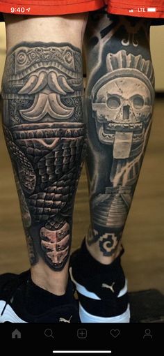 a man's legs with tattoos on them and an image of a skull in the middle