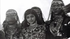 an old black and white photo of three women with painted faces