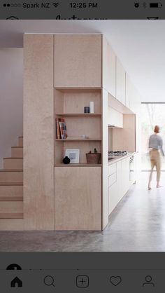 an image of a woman walking down the stairs in a house that is built into the ground