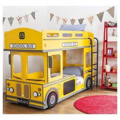 a yellow school bus bunk bed in a child's room with red rugs