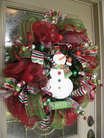 a christmas wreath with a snowman on it