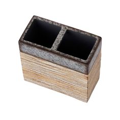 a wooden box with two black squares in it