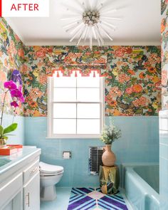 a bathroom with blue tile and floral wallpaper on the walls, along with a rug that matches the bathtub