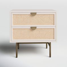 an image of a white dresser with wicker drawers on the bottom and gold handles