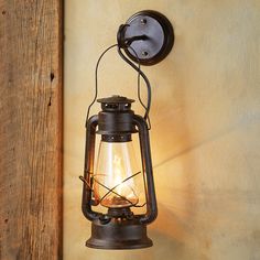 an old fashioned lantern light hanging on the wall