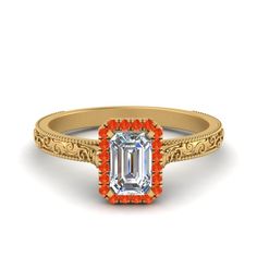 an orange and white diamond engagement ring with filigrees in yellow gold setting