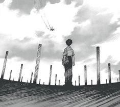 a man standing on top of a wooden pier under a cloudy sky