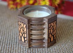 a wooden candle holder sitting on top of a table