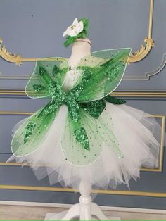 a green and white tutu skirt on top of a mannequin