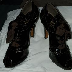 A Very Rich Chocolate Patent Leather Lace Up W/Kiltie, Peep Toe And Brown Ribbon For The Tie. 3.25 Inch Heel Beautiful Shoe...Dust Bag Included Formal Brown Heels With Brogue Detailing, Formal Lace-up Heels With Bow, Luxury Formal Heels With Brogue Detailing, Elegant High Heels With Brogue Detailing, Luxury Brown Closed-toe Lace-up Shoes, Formal High Heels With Brogue Detailing, Brown Lace-up Heels For Formal Occasions, Chic Heels With Brogue Detailing For Formal Occasions, Chic Formal Heels With Brogue Detailing