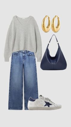 a pair of blue jeans, grey sweater and gold hoop earrings are featured in this image