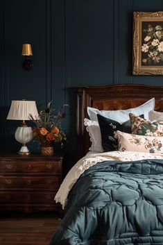 a bed in a bedroom with blue walls and wooden furniture, along with a painting on the wall