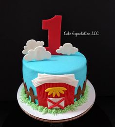 a birthday cake with the number one on it and a farm scene in the background