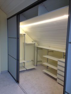 an empty walk in closet with shelves and shelving