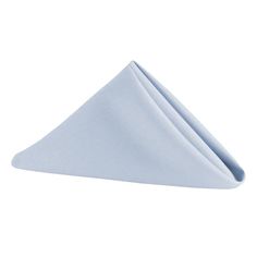 a folded napkin on top of a white table with a light blue cloth underneath it