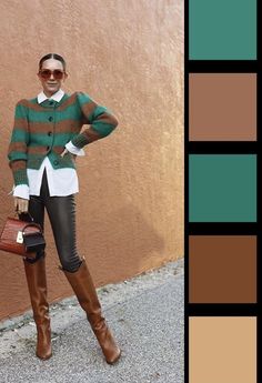 a woman standing in front of a wall wearing brown boots and a green striped sweater