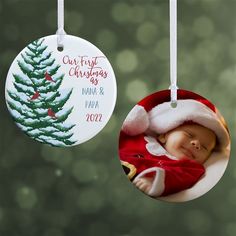 two christmas ornament hanging from a tree with a baby's photo on it