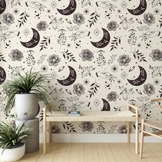 the wallpaper is decorated with black and white flowers, crescents, and stars