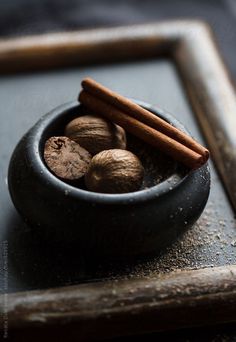 some cinnamon sticks and nuts in a bowl