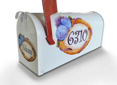 a white mailbox with grapes on it and the number 6300 painted on it